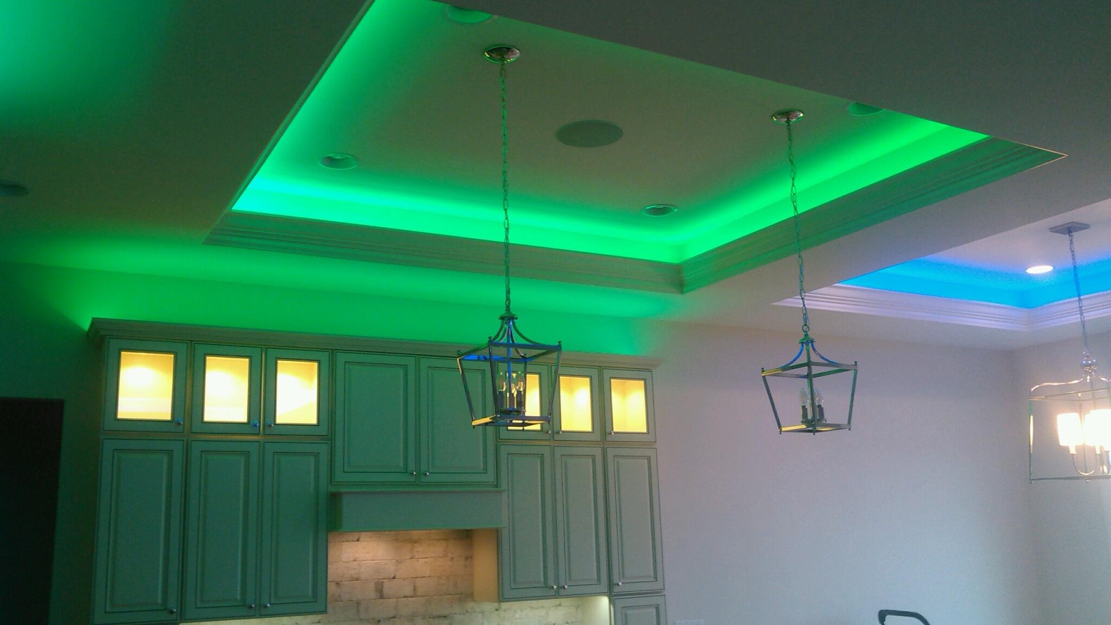 Open kitchen with green LED in the tray ceiling and lit cabinet uppers
